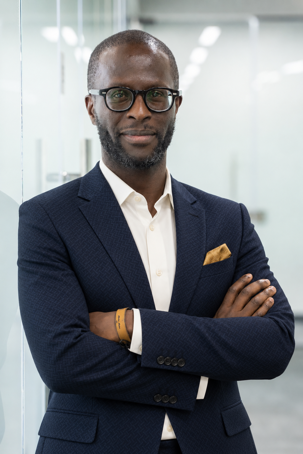 Edwin Moindi, Culture and Habit Coach, wearing a navy patterned suit